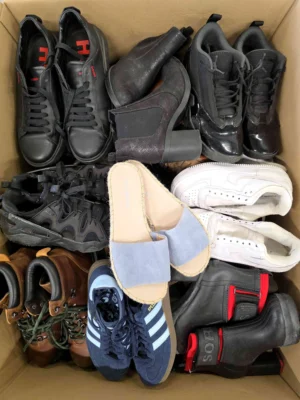 The photo shows a package with footwear in the category SH.