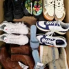 The photo shows a package with footwear in the category SH.