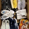 The photo shows a package with footwear in the category SH.