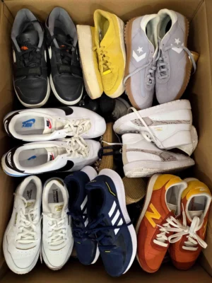 The photo shows a package with footwear in the category SH.
