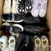 The photo shows a package with footwear in the category SH.