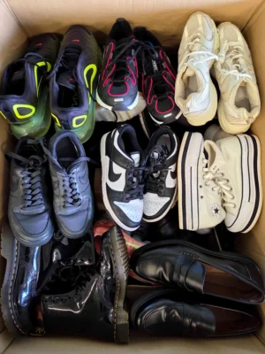 The photo shows a package with footwear in the category SH.