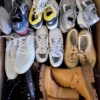 The photo shows a package with footwear in the category SH.