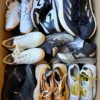 The photo shows a package with footwear in the category SH.