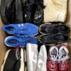 The photo shows a package with footwear in the category SH.