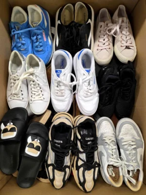 The photo shows a package with footwear in the category SH.