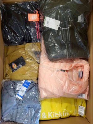 The photo shows a package with clothing in the category AJS.