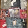 The photo shows a package with clothing in the category AW.