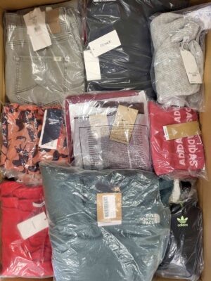 The photo shows a package with clothing in the category AW.