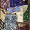 The photo shows a package with clothing in the category AW.