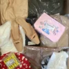 The photo shows a package with clothing in the category SN.