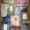 The photo shows a package with clothing in the category AP.
