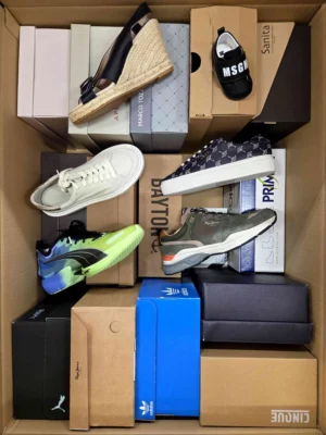 The photo shows a package with footwear in the category AS.