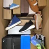 The photo shows a package with footwear in the category AS.