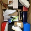 The photo shows a package with footwear in the category AS.