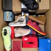 The photo shows a package with footwear in the category AS.