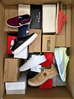 The photo shows a package with footwear in the category AS.