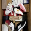 The photo shows a package with footwear in the category AS.
