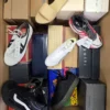 The photo shows a package with footwear in the category AS.