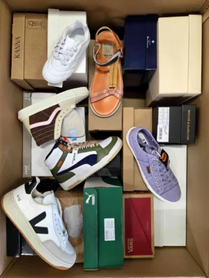 The photo shows a package with footwear in the category AS.