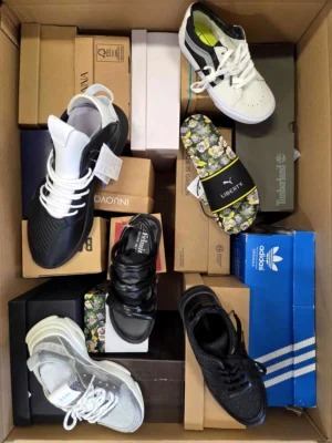 The photo shows a package with footwear in the category AS.