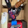 The photo shows a package with footwear in the category AS.
