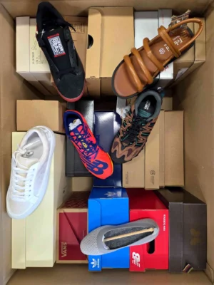 The photo shows a package with footwear in the category AS.