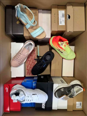 The photo shows a package with footwear in the category AS.