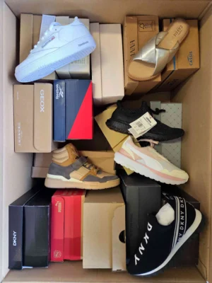 The photo shows a package with footwear in the category AS.