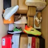 The photo shows a package with footwear in the category AS.