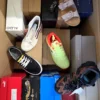 The photo shows a package with footwear in the category AS.
