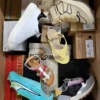 The photo shows a package with footwear in the category AS.