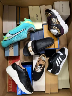 The photo shows a package with footwear in the category AS.