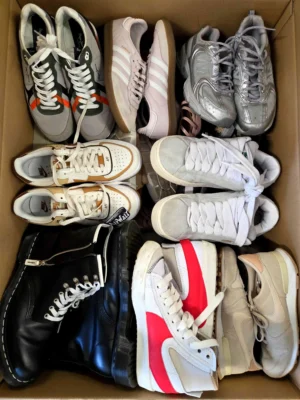 The photo shows a package with footwear in the category SH.