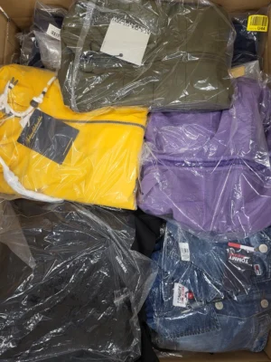 The photo shows a package with clothing in the category AJS.