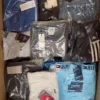 The photo shows a package with clothing in the category AM.