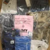 The photo shows a package with clothing in the category AM.