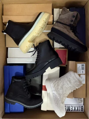 The photo shows a package with footwear in the category AS.