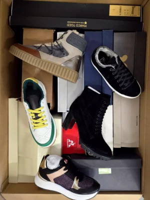 The photo shows a package with footwear in the category AS.