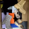 The photo shows a package with footwear in the category AS.