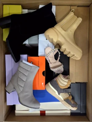 The photo shows a package with footwear in the category AS.