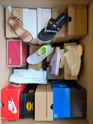 The photo shows a package with footwear in the category AS.