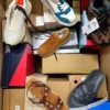 The photo shows a package with footwear in the category AS.