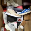 The photo shows a package with footwear in the category AS.