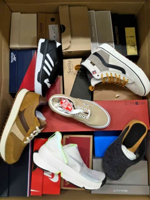 The photo shows a package with footwear in the category AS.