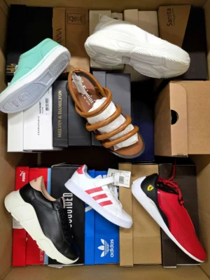 The photo shows a package with footwear in the category AS.