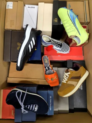 The photo shows a package with footwear in the category AS.