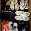 The photo shows a package with footwear in the category SH.