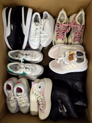 The photo shows a package with footwear in the category SH.