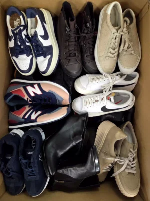 The photo shows a package with footwear in the category SH.